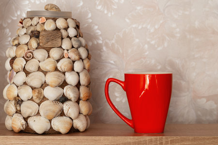 Orange mug and handmade vase in the apartment interior.の写真素材