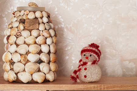 Snowman and handmade vase in the apartment interior.の写真素材