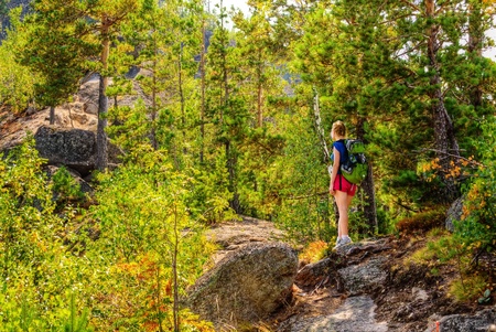 Woman walks up the mountainの写真素材