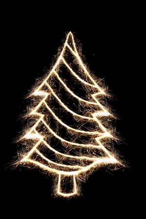 Christmas tree by sparkler style with freeze light on black backgroundの写真素材