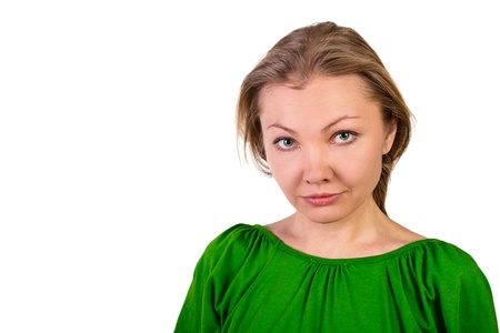 Beautiful shy woman stares at camera isolated on whiteの写真素材