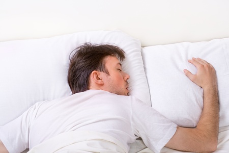 Man sleeps on bed with very deep sleepの写真素材