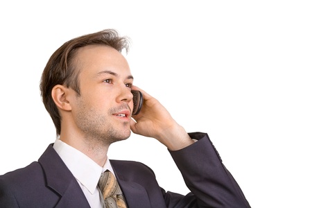 Smiling businessman talks on phone isolated on whiteの写真素材
