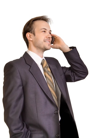 Smiling businessman talks on phone isolated on whiteの写真素材