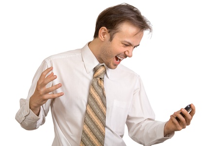 Businessman in white shirt shouts on phone isolated on whiteの写真素材