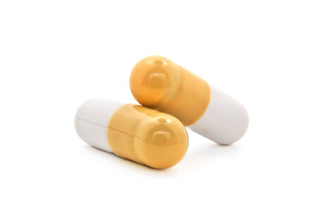 Macro shot of two pills with medical drug insideの写真素材