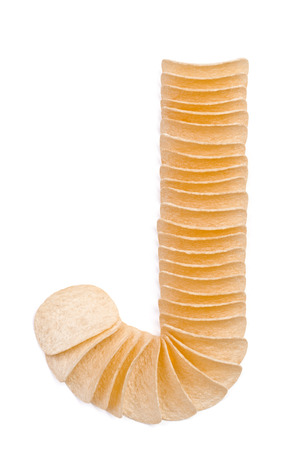 Letter J composed of chips isolated on white backgroundの写真素材