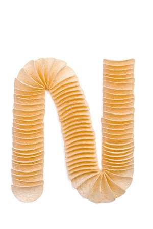 Letter N composed of chips isolated on white backgroundの写真素材