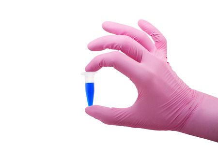 Hand in gloves keeps plastic tube with blue fluid isolated on white backgroundの写真素材