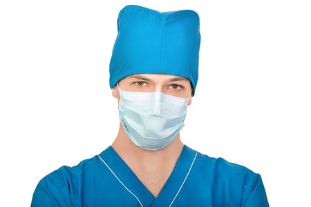Medic in mask looks in camera isolated on white backgroundの写真素材