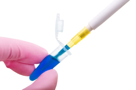 Hand in glove keeps plastic tube with dipped pipette isolated on white backgroundの写真素材