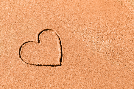 Drawed heart on the beach sand - romantic conceptの写真素材