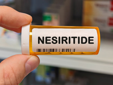 orange plastic Box of tablets on a hospital pharmacy table used to treat acute heart failure and...