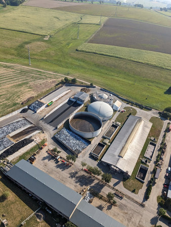 Aerial panorama landscape of biogas power plant and surrounding agricultural landscape showing biogas production, bioenergy generation, and green renewable electricity during the European energy crisisの写真素材
