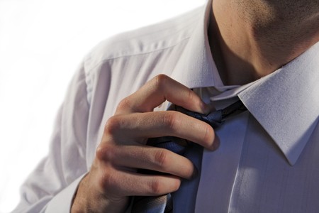 Business man pulling the tieの写真素材