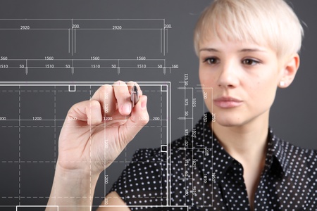 Hand and blueprint - engineer working on blue print conceptの写真素材