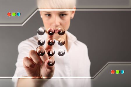 Attractive blonde with futuristic interface (business people technology concept)の写真素材