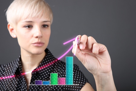 Attractive blonde with pen drawing growth (business people technology concept)の写真素材