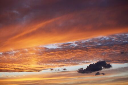Beautiful red sunset over the italian sea, rich dark and light cloudsの写真素材
