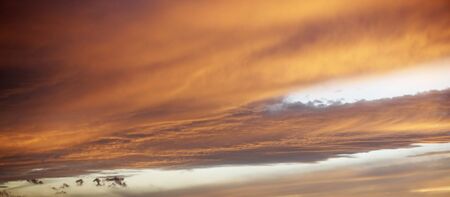 Beautiful red sunset over the italian sea, rich dark and light clouds