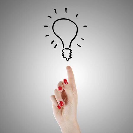 Light bulb and hand - new idea conceptの写真素材