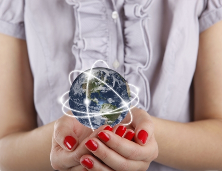 Business woman holds Earth in handsの写真素材