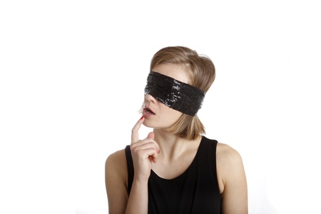 Portrait of a young woman blindfold isolated on whiteの写真素材