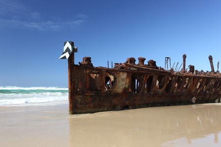 Rusty shipwreck on tropical beach - the Maheno, Fraser Island, Queensland, Australiaの写真素材
