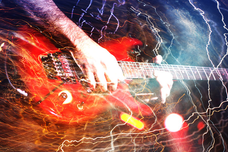 Guitar player with white electric guitar surrounded by lightnings