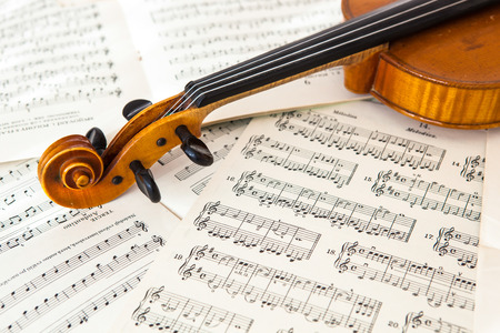 Old violin lying on the sheet of music, music conceptの写真素材