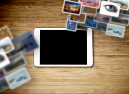 Tablet lying on the table with blank screenの写真素材
