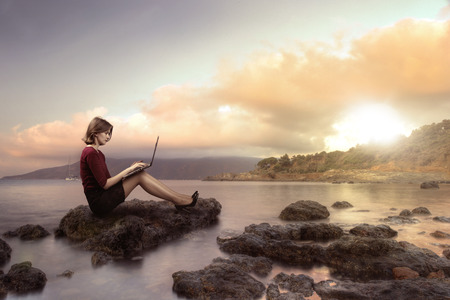 Business woman working on the beach during the holidaysの写真素材