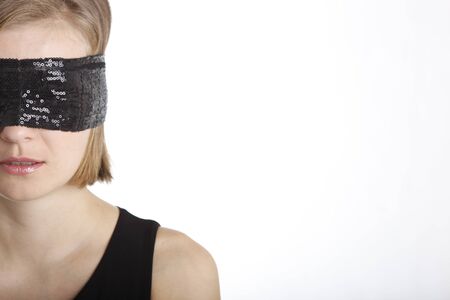 Portrait of a young woman blindfold isolated on whiteの写真素材