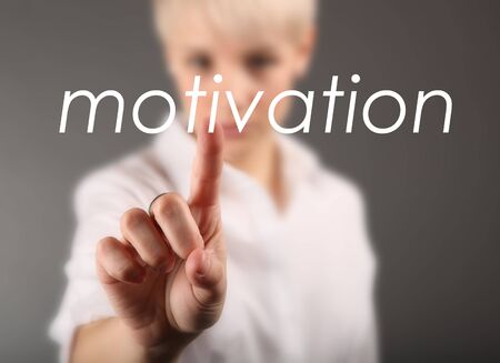 Girl touching screen with motivation business conceptの写真素材