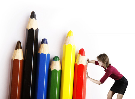 Color pencils arranged by businesswoman on white backgroundの写真素材