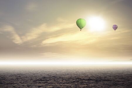 Colorful hot air balloons high in the sky and cloudsの写真素材