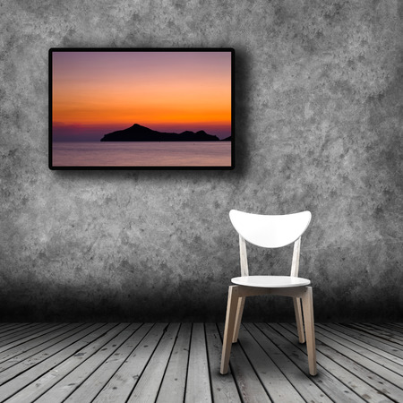 Plasma TV on the wall of the room with wooden floor and empty chairの写真素材