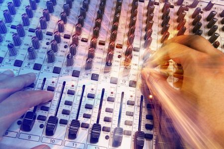 Professional radio / TV broadcasting audio mixing console with faders and adjusting knobsの写真素材