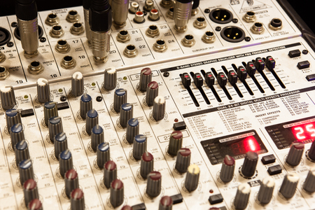 Sound studio record equipment with faders and adjusting knobs
