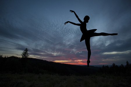 Ballet dancer posing during the sunset, silhouette conceptの写真素材