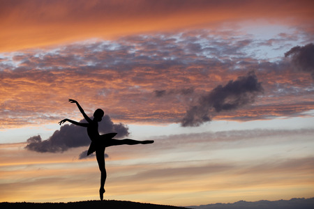 Ballet dancer posing during the sunset, silhouette conceptの写真素材