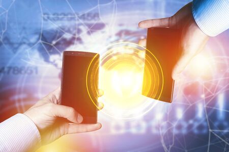 Peer-to-peer payment concept with map and world connection , Businessmen holding smartphones....