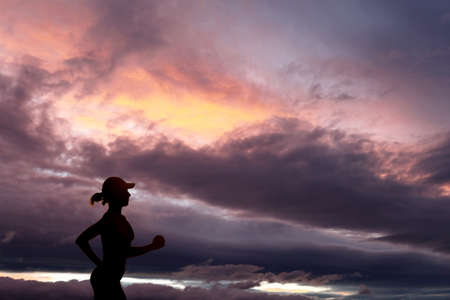 Runner during sunset - fitness work out concept, silhouetteの写真素材