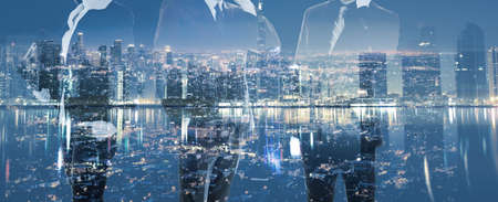 Double exposure businessman standing in front of the nigh city. Strategy business concept