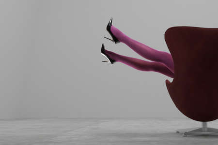Woman's Legs Wearing Pantyhose and High Heels Woman's Legs Wearing Pantyhose and High Heels in modern interior with space for textの写真素材