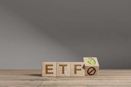 Wood cubes with acronym 'ETF' - 'Exchange Traded Fund' on a beautiful wooden table, studio background. Business concept with copy space.の写真素材