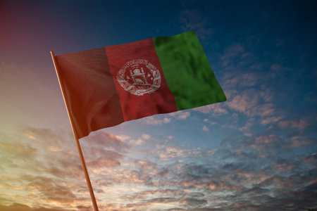 Flag of Afghanistan flying in the wind with flag pole, cloudy day, 3D rendering