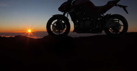 Motorbike parking with sunset background. Biker ride motorcycle. Silhouette of the motobike. Trip and lifestyle motorbike Concept.の写真素材