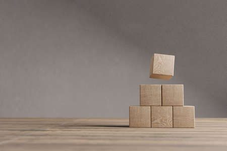 Arranged wood cube stacking as shape, mock up for create symbol or logo, business growth and management concept.の写真素材
