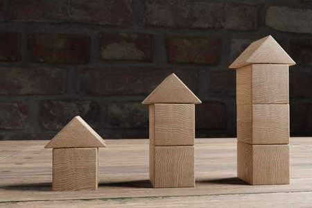 Real estate investment concept with wooden cubes , house selection concept, 3D renderingの写真素材